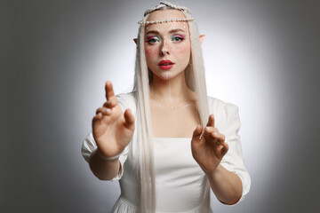 Obraz premium Beautiful elf girl on grey gradient background