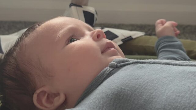 Happy and playful baby on floor 4k