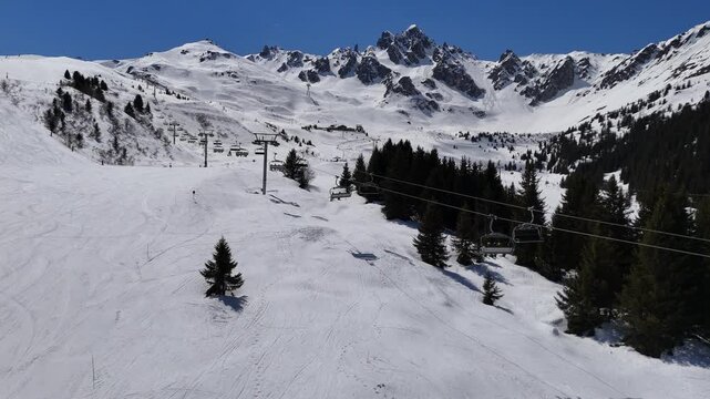 Aerial view of ski lifts in Courchevel ski resort slopes by winter, French alps