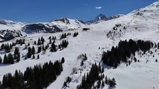 Aerial view of ski lifts in Courchevel ski resort slopes by winter, French alps