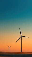 Obraz premium Wind Turbines Silhouetted Against Sunset Sky