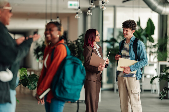 University students and teacher talking on campus, diverse group discussing education, learning, and college life