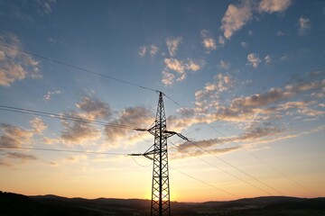 High voltage transmission tower in green landscape during sunset aerial panorama of energy infrastructure © Semi