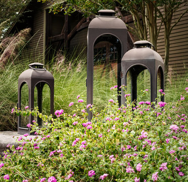 large lanterns in a garden of flowers