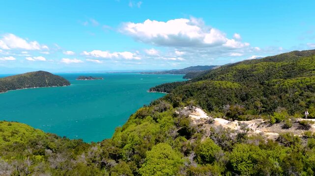 Aerial view of the turquoise waters meeting the lush green forests in Abel Tasman National Park, a beautiful contrast of nature's colors, Abel Tasman National Park, Tasman Region, New Zealand.