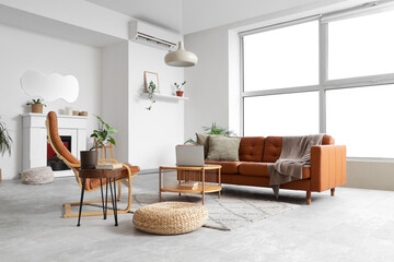 Interior of light living room with stylish mirror, brown sofa and armchair © Pixel-Shot