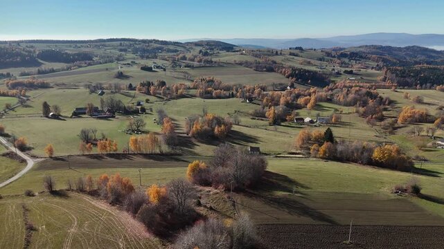 Aerial view of rolling hills, fields, and forests with vibrant autumn colors create a picturesque landscape, Detvianska Huta, Banska Bystrica Region, Slovakia.