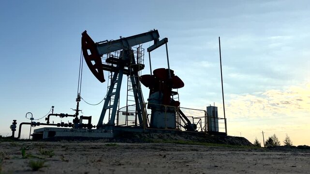 Extraction of petroleum. Oil Pump Jack on blue. Oil Field. Petrolium crude Industrial. Crude pump jack working.. Extraction of petroleum in oilfield. Crude petroleum industry