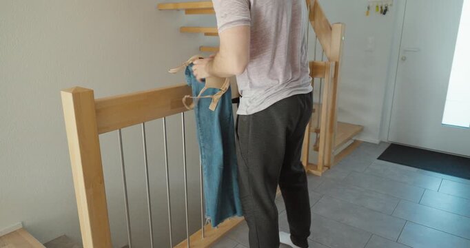 Man Organizing Clothes at Home &ndash; Cleaning and Daily Routine Concept