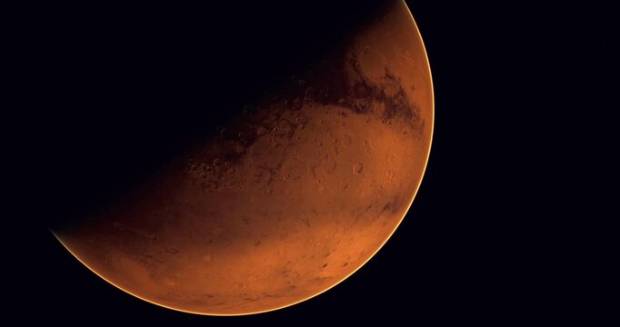 The reddish planet Mars reveals its rocky terrain and surface features in this captivating view from space, showcasing its distinct colors and atmospheric conditions in detail.