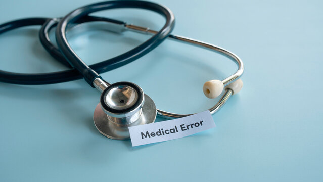 Professional medical stethoscope on blue surface with medical error text