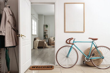 Interior of hallway with bicycle, blank frame and open door © Pixel-Shot