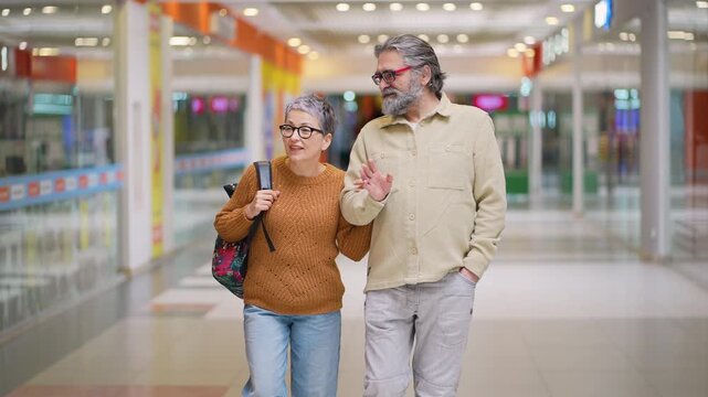 Older couple shopping and talking at a store