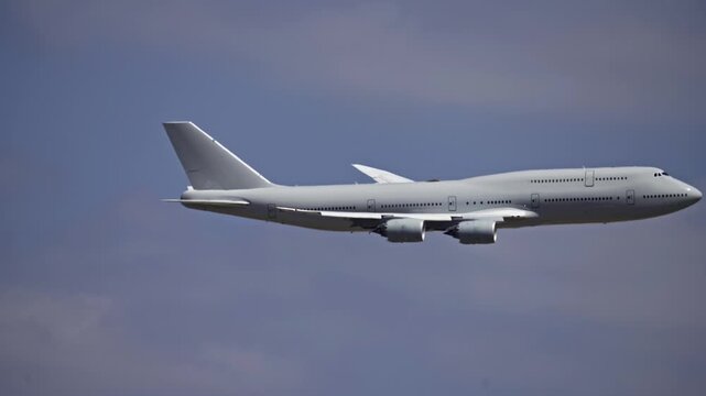 Large Cargo Military Freighter Airplane Profile Tracking Shot in Sky.