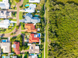 Aerial View of a Modern Residential Community with Solar Homes and Pools Bordering Lush Australian Bushland in Queensland © Mujie