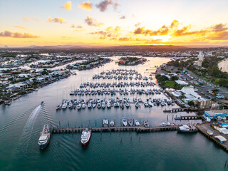 Golden Sunset over Mooloolah River Marina and Residential Canals, Point Cartwright, showcasing many boats docked along the Sunshine Coast. © Mujie