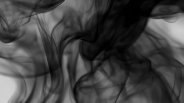 An abstract image of black smoke or ink swirling, creating an ethereal, flowing texture