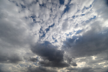 Fototapeta premium Brooding clouds gather over horizon, deep shadows and cool palette create moody, filmic tension suitable for editorial, climate or suspense storytelling backdrops
