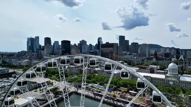 Aerial drone view of La Grande Roue de Montreal in the Old Port with downtown skyline, Quebec, Canada