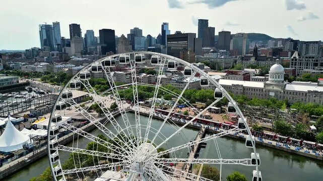Aerial drone view of La Grande Roue de Montreal in the Old Port with downtown skyline, Quebec, Canada
