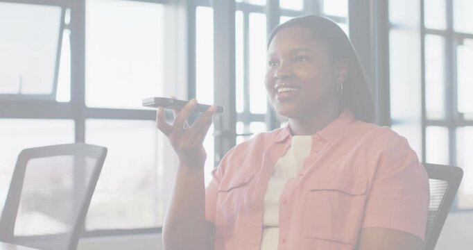 Bringing smartphone closer, office woman making work call in mesh chair, pink shirt