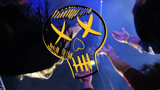 Vertical video: Lifting crowd raising hands to touch disco ball under yellow skull, lights lowering