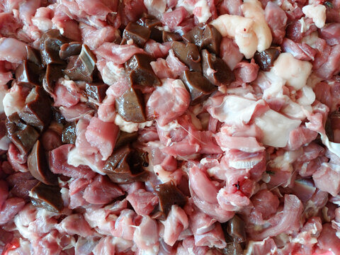 Fresh raw lamb or goat meat chopped into small pieces with liver and fat for satay. Traditional mutton meat preparation for barbecue and culinary cooking.