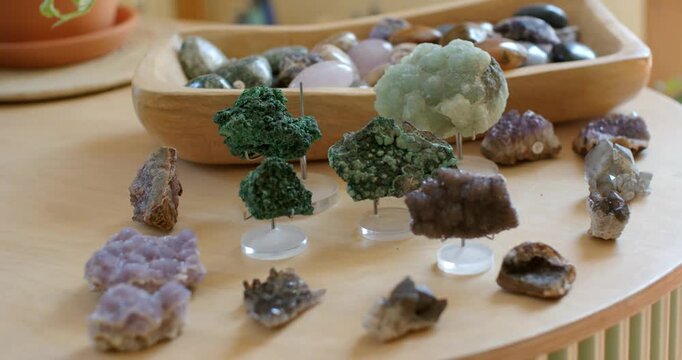 Camera sliding in focusing on three mounted green crystals with pale piece behind showing texture