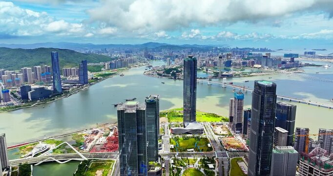 Drone view of Zhuhai modern skyscrapers and Macau city skyline across the water, China