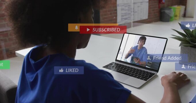 woman sitting at desk viewing laptop IT host, play icon popping and badges rising, showing response