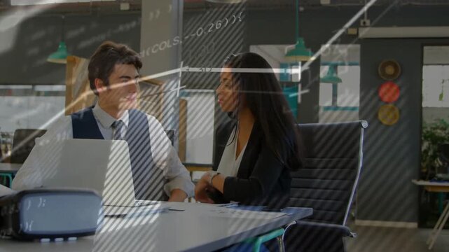 Vertical video: Discussing laptop overlays sparking mentor showing mentee in office, shaking hands