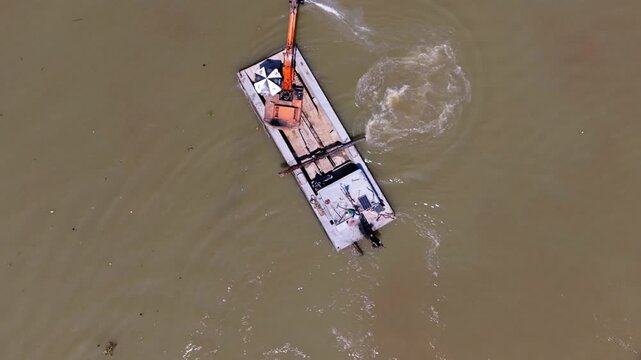 Excavator Creates Whirlpools. Machine Stirs Water In Circles. Circular Digger Forms Swirling Water Patterns. Orange Excavator Crafts Rotating Whirlpools From Water With Spiral Digging