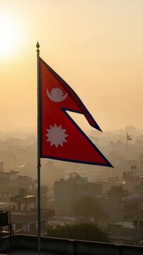 Triangular national flag waving over a misty urban cityscape during golden hour sunrise