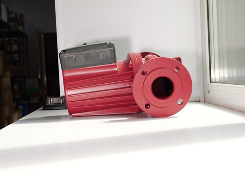 Red electric industrial pump isolated on white