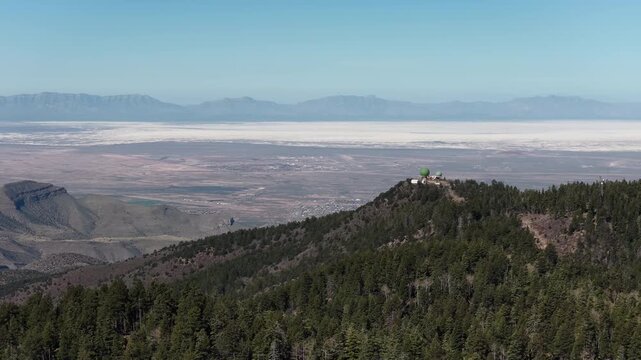 Aerial of Alamo peak observatory in Sacramento Mountains above White Sands in New Mexico