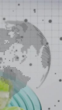 Vertical video: Cue causing dot globe rotating while teal bowl rising, showing salad for food ad