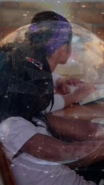 Vertical video: Start with two students writing in class under data globe drifting across frame