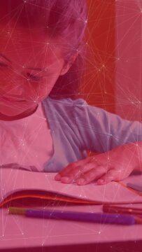 Vertical video: Camera zooming girl leaning over book reading pens red network overlay aiding study