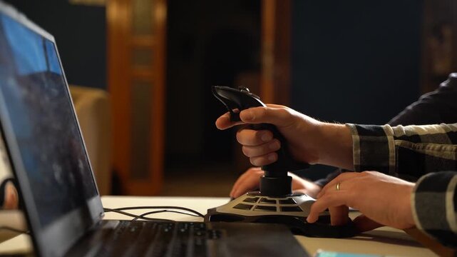Close up of a persons hand using a precision gaming joystick
