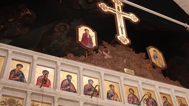 icons and a golden cross inside the ancient Christian Monastery of Ma'aloula, Syria. Traditional Orthodox interior showing sacred religious art and historical heritage