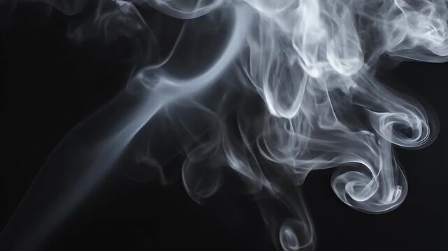 Abstract white smoke swirls rising gracefully to create elegant and ethereal patterns in the dark atmosphere