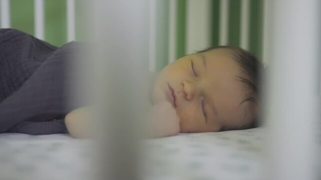 Baby with jaundice sleeping in crib