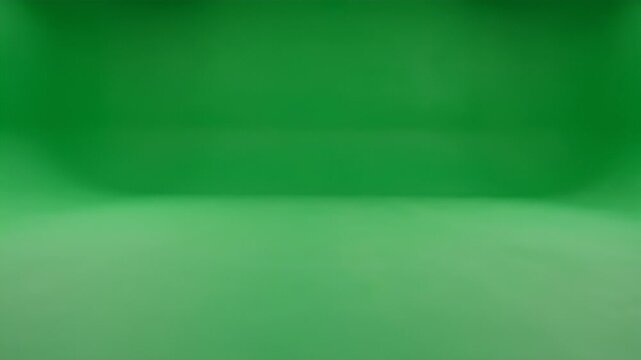 An empty studio space features a vibrant green screen backdrop and a reflective floor, ready for filming or photography.