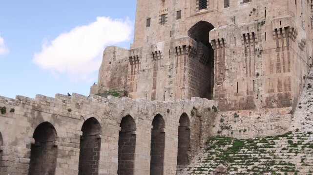 Close-up architectural shot of the ancient stone arches and vaulted structures inside the Aleppo Citadel