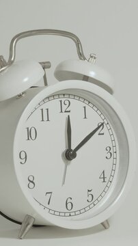 Tme lapse video of a clock time passing over a day to night on white background.
