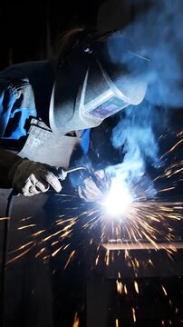 Welder in action sparks fly in industrial production environment