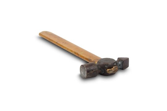 A closeup view of a vintage ballpeen hammer with a wooden handle on a white background