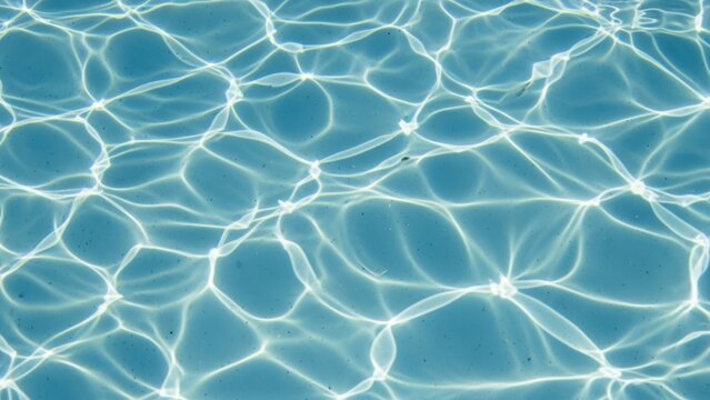 Sunlight Reflection Patterns on Blue Pool Water