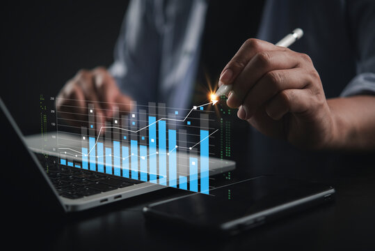 Businessman hand touching virtual glowing digital graph stylus financial data analysis stock market trading investment growth laptop.