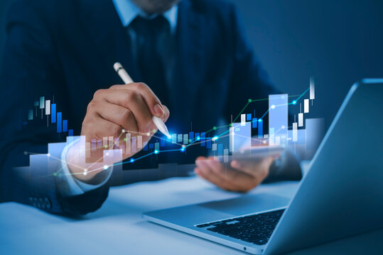 Businessman stylus touching virtual glowing candlestick stock market trading graph financial analysis digital investment strategy laptop desk corporate finance future.